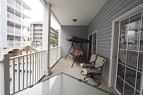 Sky Blue Vacation Condo, Myrtle Beach - Lower Balcony with three person swing, table, four chairs